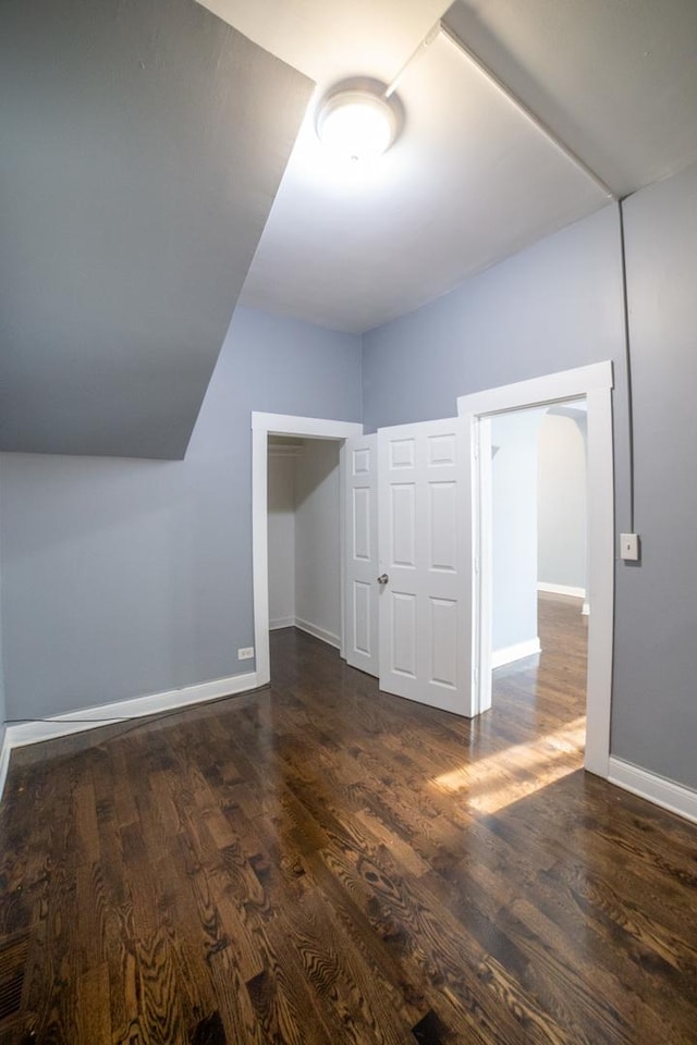 additional living space featuring dark hardwood / wood-style floors