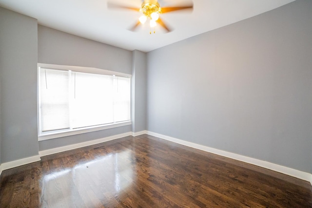 unfurnished room featuring ceiling fan and dark hardwood / wood-style floors