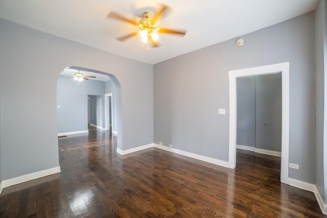 spare room with ceiling fan and dark hardwood / wood-style floors