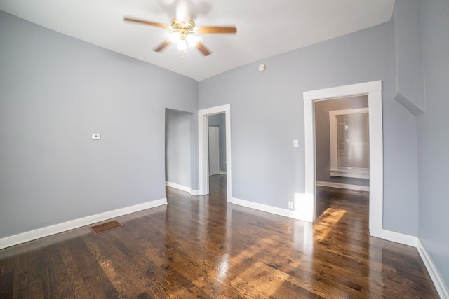 spare room featuring dark hardwood / wood-style floors and ceiling fan