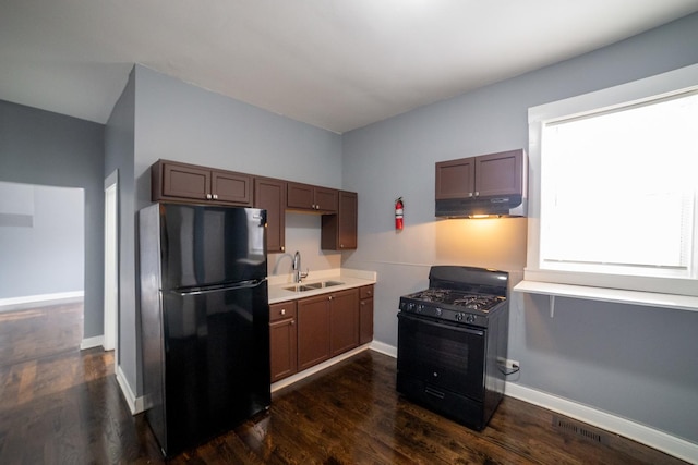 kitchen featuring dark wood-type flooring, sink, and black appliances