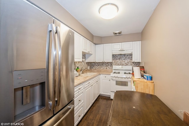 kitchen with backsplash, sink, stainless steel refrigerator with ice dispenser, white gas stove, and white cabinetry