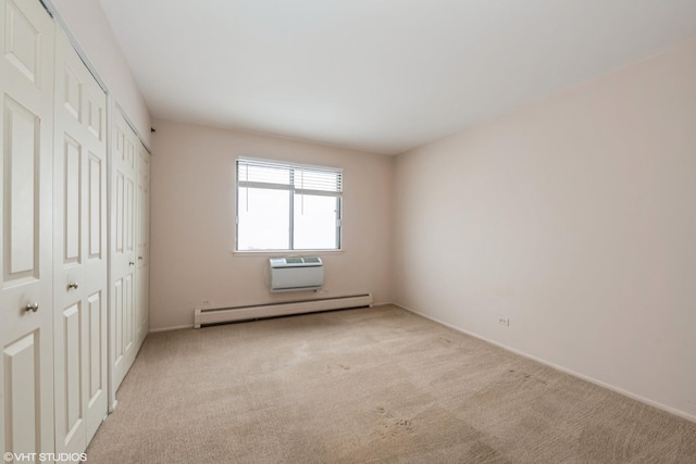 unfurnished bedroom featuring light carpet, an AC wall unit, and a baseboard heating unit