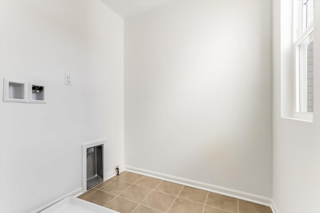 clothes washing area featuring light tile patterned floors