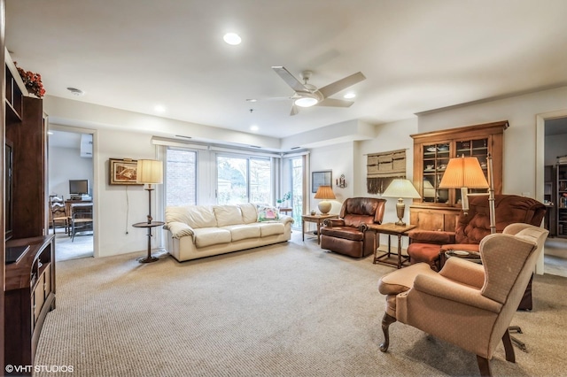 living room with light colored carpet and ceiling fan