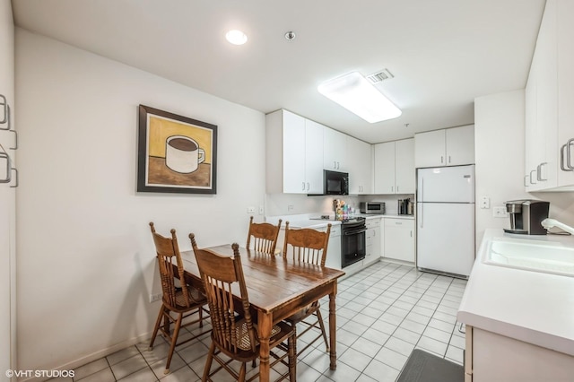 tiled dining area featuring sink