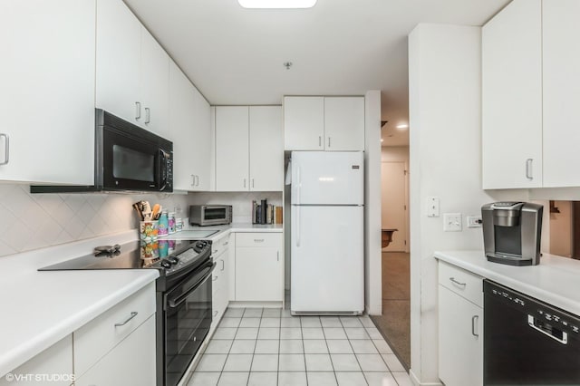 kitchen featuring white cabinets, backsplash, light tile patterned flooring, and black appliances