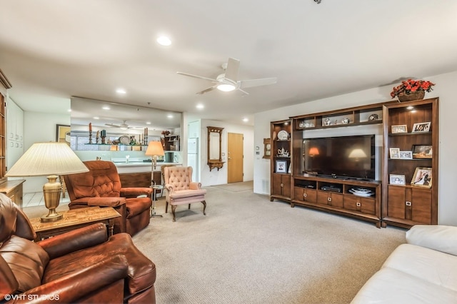 carpeted living room with ceiling fan