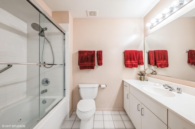 full bathroom with tile patterned flooring, vanity, toilet, and combined bath / shower with glass door