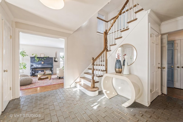 foyer featuring ornamental molding