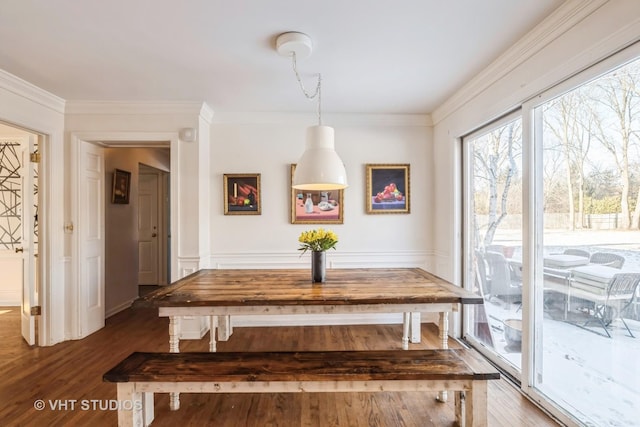 dining area with dark hardwood / wood-style flooring and crown molding