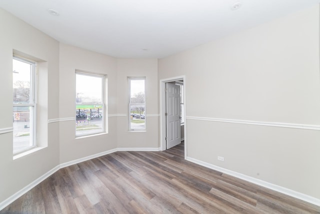 unfurnished room featuring hardwood / wood-style floors and plenty of natural light