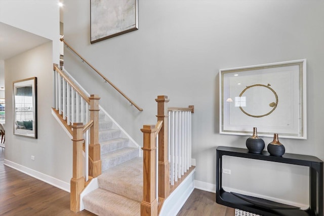 stairway featuring wood-type flooring