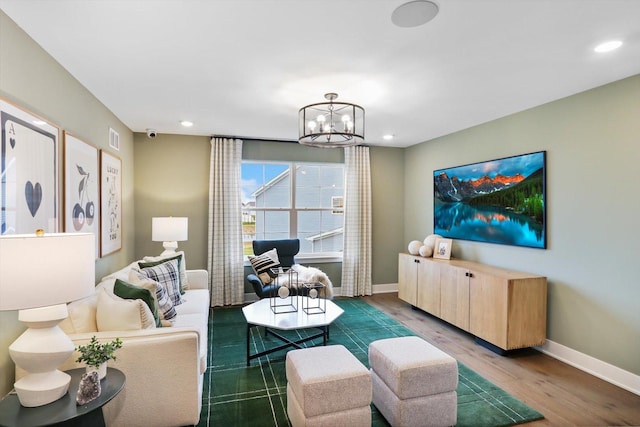 living room featuring dark hardwood / wood-style flooring and a notable chandelier