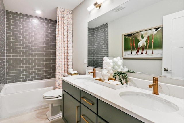 full bathroom featuring shower / bath combination with curtain, toilet, and vanity