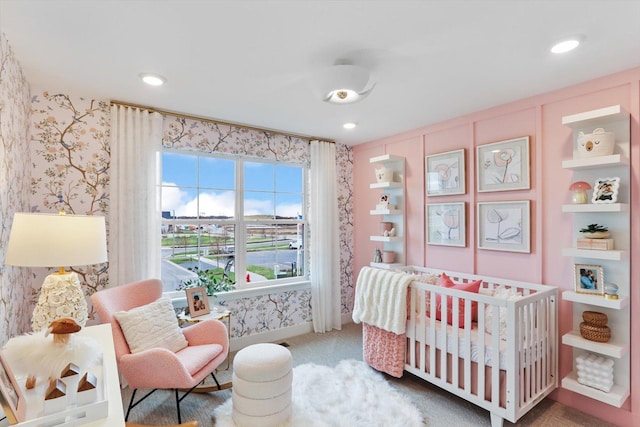 carpeted bedroom featuring a crib