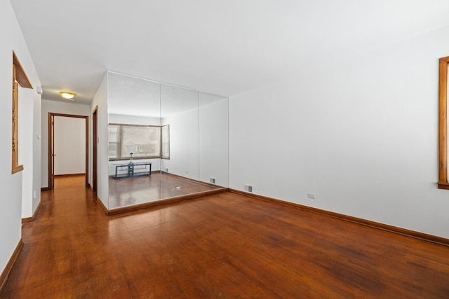 unfurnished living room featuring wood-type flooring