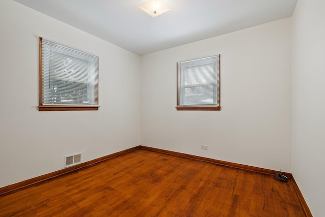 spare room with hardwood / wood-style floors