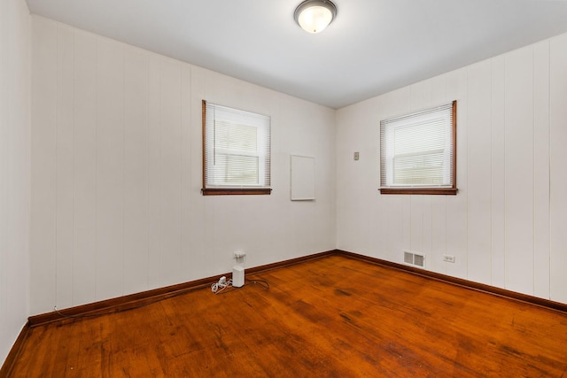 spare room with wood-type flooring