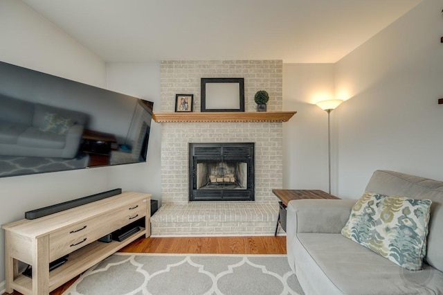 sitting room featuring a fireplace and light hardwood / wood-style flooring