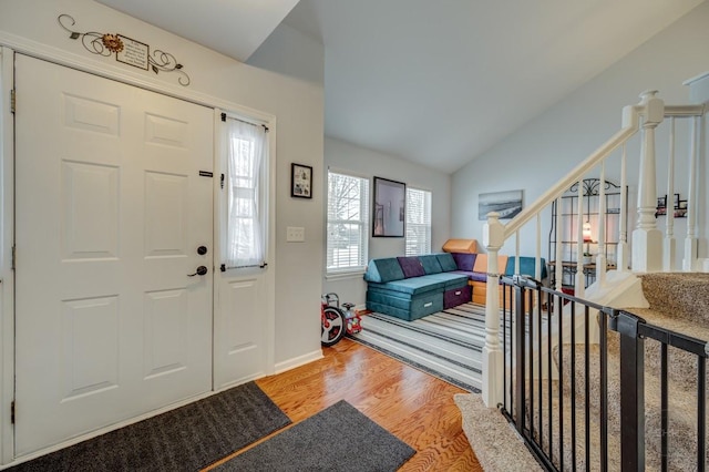 entryway featuring hardwood / wood-style flooring and lofted ceiling