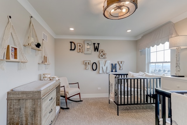 carpeted bedroom with crown molding and a crib