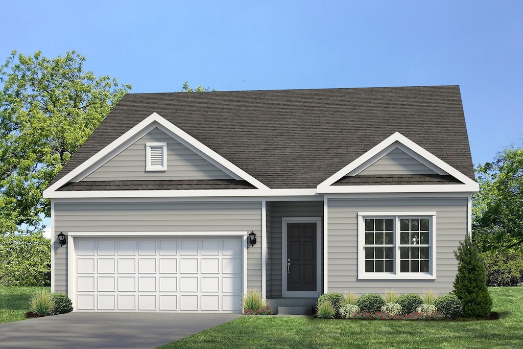 view of front of property with a front yard and a garage