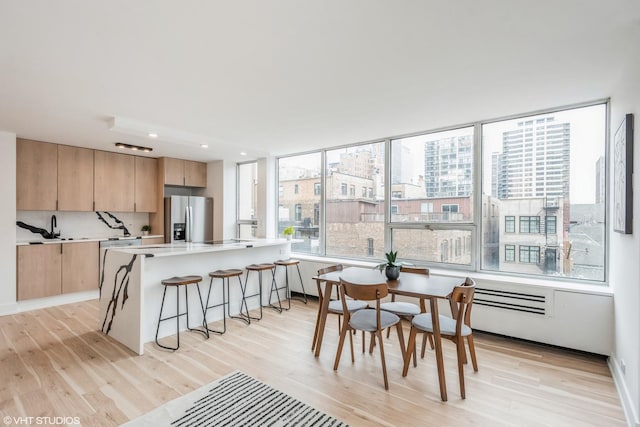 dining area featuring sink and light hardwood / wood-style flooring