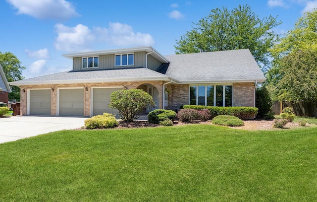 view of front of property with brick siding, roof with shingles, a garage, driveway, and a front lawn