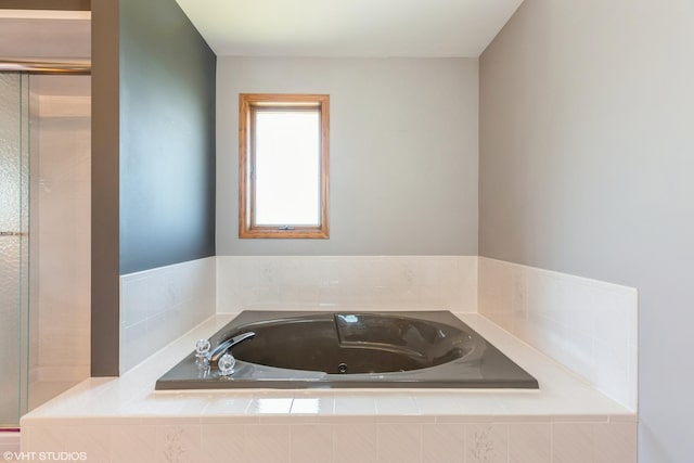 bathroom featuring tiled bath