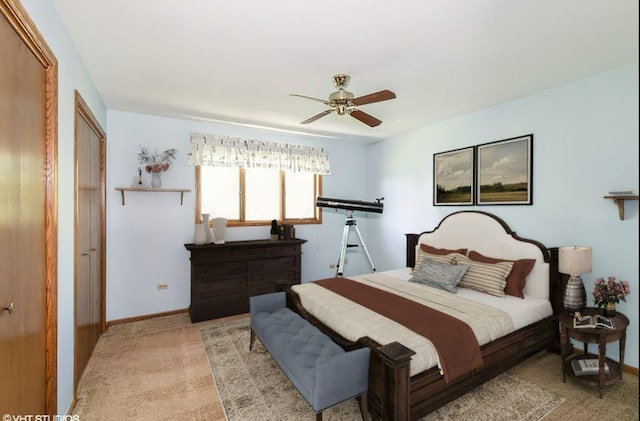 bedroom with ceiling fan, baseboards, and light colored carpet