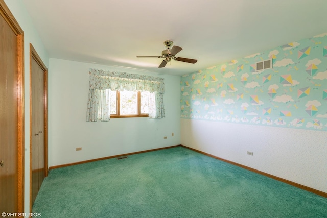 unfurnished bedroom featuring carpet flooring, a ceiling fan, baseboards, visible vents, and wallpapered walls