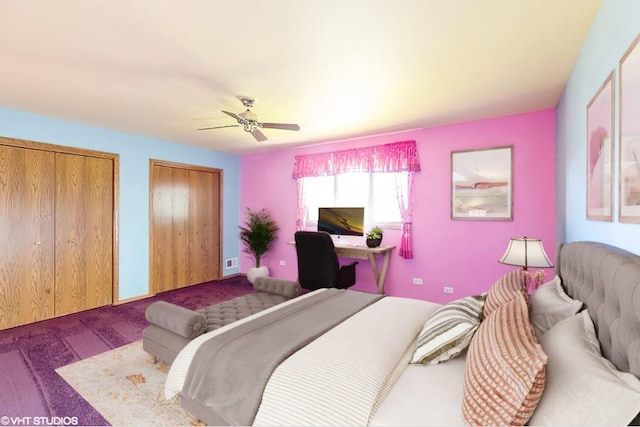 carpeted bedroom with two closets and a ceiling fan