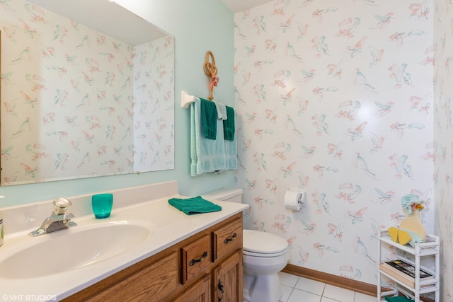 bathroom with tile patterned floors, vanity, and toilet