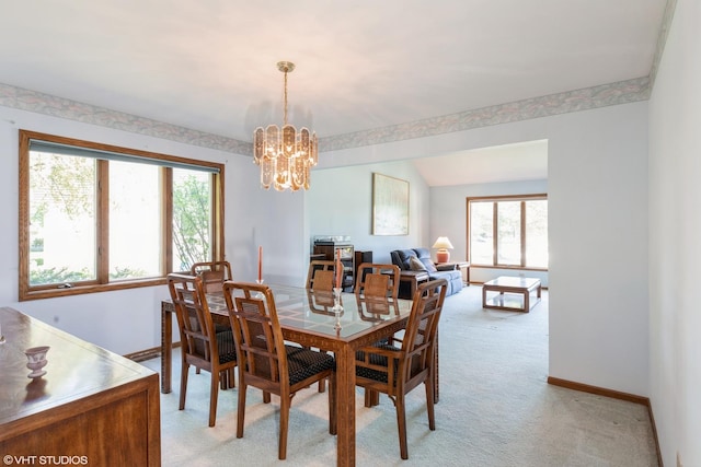 dining space with baseboards, a notable chandelier, and light colored carpet