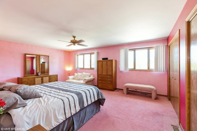 bedroom with ceiling fan and light carpet