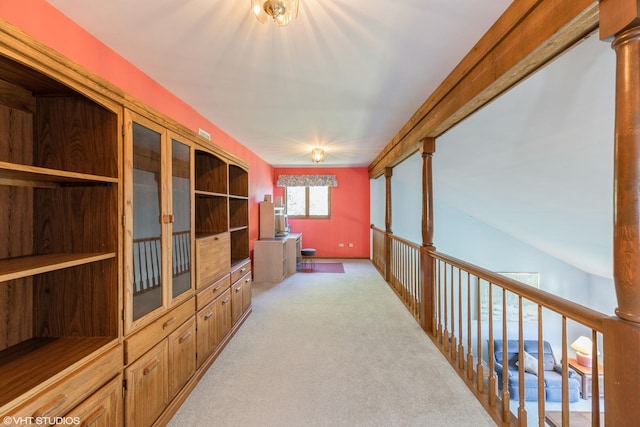 hallway featuring light colored carpet