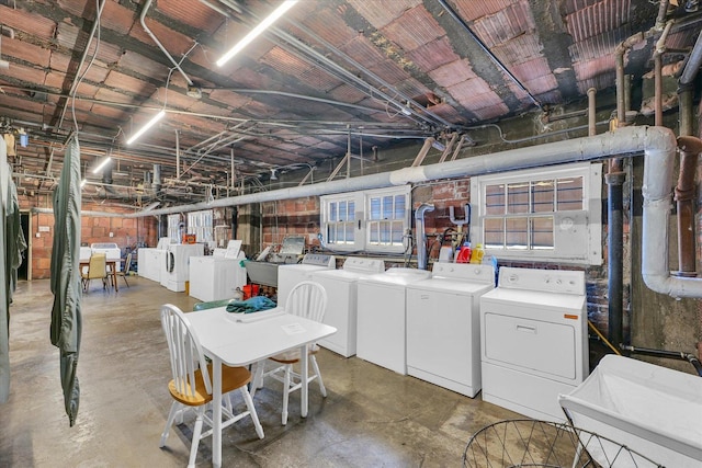 basement featuring washing machine and clothes dryer and sink