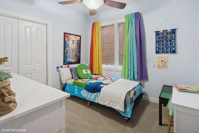 carpeted bedroom featuring ceiling fan and a closet