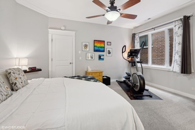 bedroom with ceiling fan, crown molding, and carpet floors