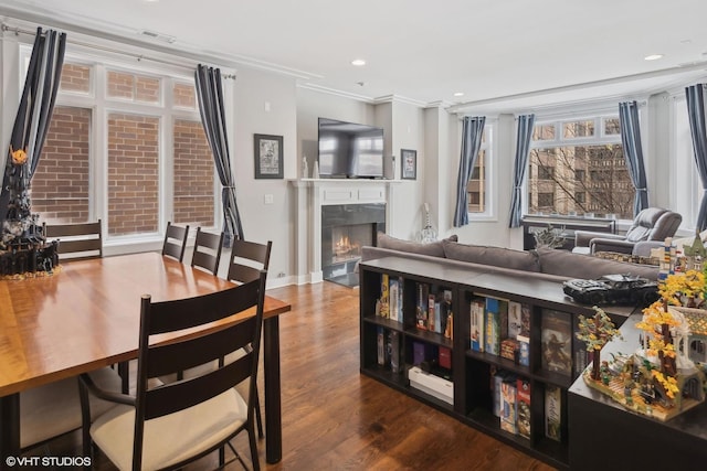 dining room featuring wood-type flooring and crown molding