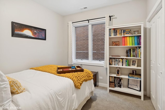 bedroom with light colored carpet and a closet