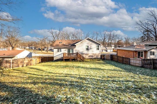 back of property with a lawn and a wooden deck