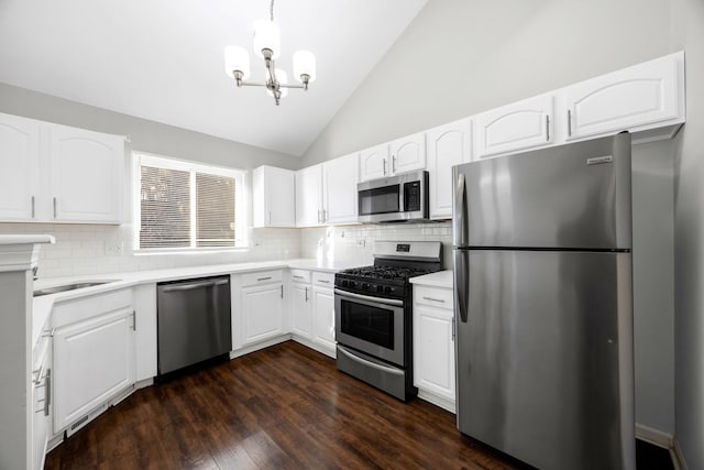 kitchen featuring white cabinets, appliances with stainless steel finishes, and backsplash