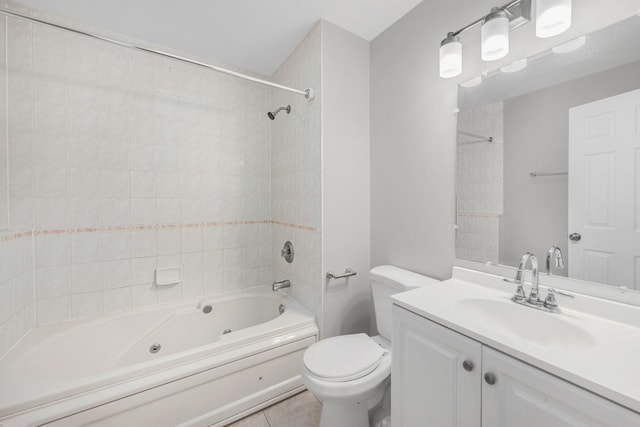 full bathroom with tile patterned floors, toilet, vanity, and tiled shower / bath