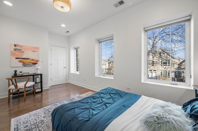 bedroom featuring dark wood-type flooring and multiple windows