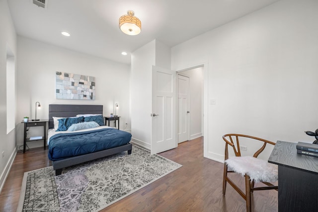 bedroom with dark hardwood / wood-style floors