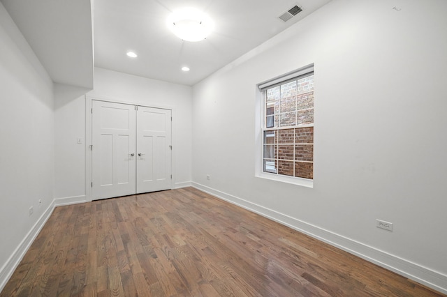 spare room with wood-type flooring