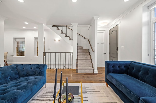 living room featuring ornamental molding and light hardwood / wood-style floors