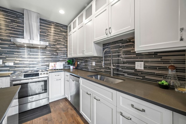 kitchen with sink, range hood, white cabinetry, and stainless steel appliances